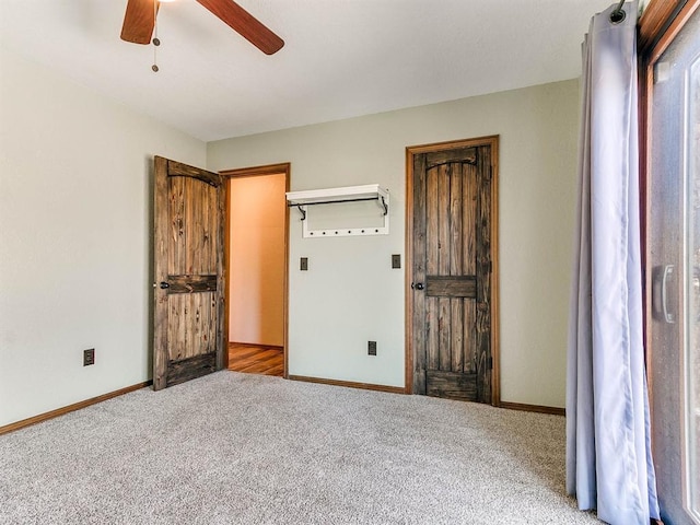 unfurnished bedroom featuring carpet, baseboards, and a ceiling fan