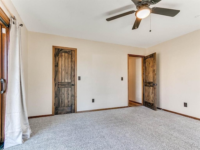 unfurnished bedroom with carpet floors, baseboards, and a ceiling fan