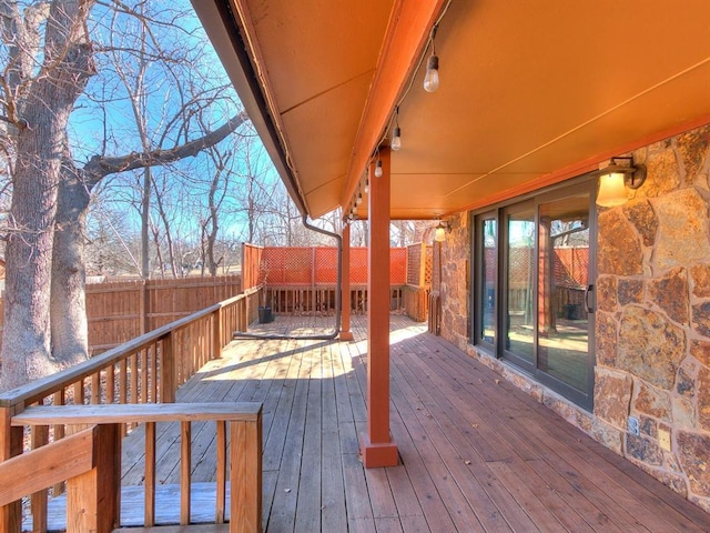 wooden terrace featuring fence