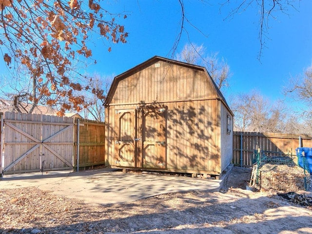 view of shed featuring a gate and fence