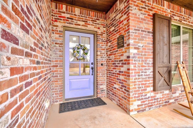 property entrance featuring brick siding