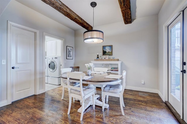 dining room featuring washer and clothes dryer, dark wood finished floors, beam ceiling, and baseboards