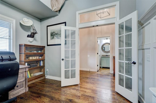 office area featuring french doors, baseboards, and wood finished floors