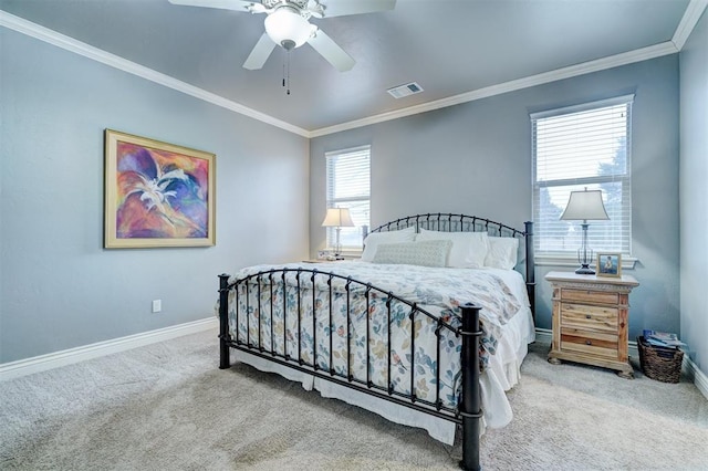 carpeted bedroom featuring crown molding, a ceiling fan, visible vents, and baseboards