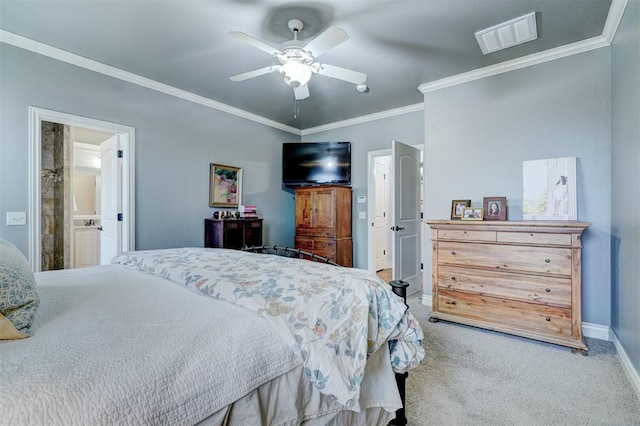 carpeted bedroom featuring ceiling fan, ensuite bathroom, visible vents, baseboards, and crown molding