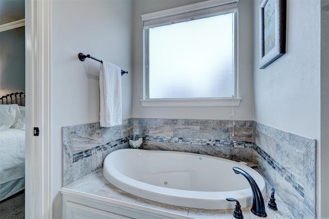 ensuite bathroom with connected bathroom and a bath