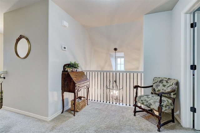 sitting room featuring carpet and baseboards