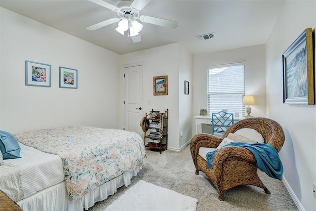 bedroom featuring baseboards, visible vents, a ceiling fan, and light colored carpet