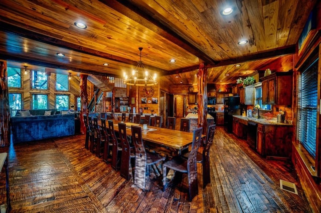 dining area featuring visible vents, wooden ceiling, a notable chandelier, beam ceiling, and recessed lighting