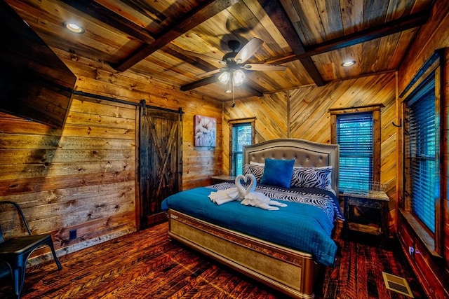 bedroom featuring a barn door, beamed ceiling, wooden ceiling, and visible vents