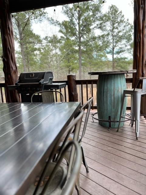 wooden deck featuring exterior bar