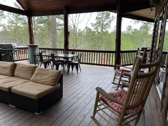 wooden deck featuring outdoor dining space and grilling area