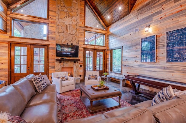 living area with high vaulted ceiling, french doors, wood walls, and wood ceiling