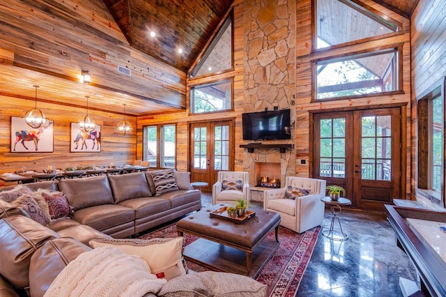 living area with french doors, wood walls, and wood ceiling