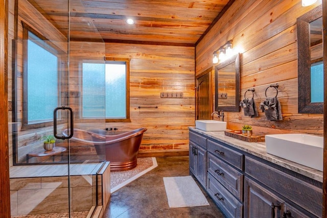 full bath featuring a sink, wood walls, and a freestanding bath