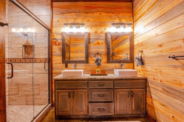 bathroom with double vanity, a sink, and a shower stall