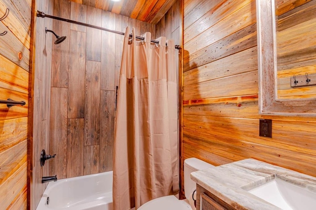 bathroom featuring toilet, wooden walls, shower / bath combination with curtain, and vanity