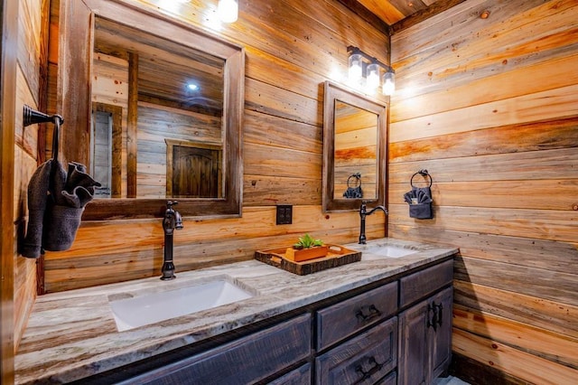 full bathroom featuring double vanity, wood walls, and a sink