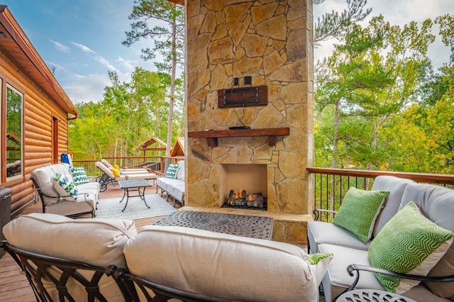 deck with an outdoor living space with a fireplace