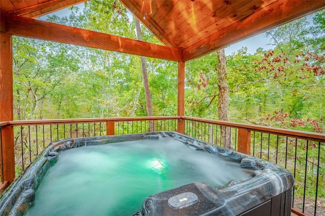 wooden deck featuring a hot tub