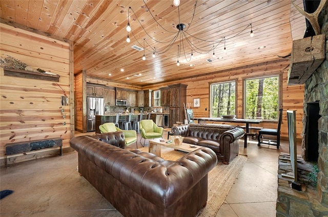 living area with visible vents, wood walls, and wood ceiling