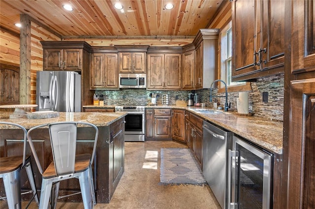 kitchen with wine cooler, stainless steel appliances, tasteful backsplash, wood ceiling, and a sink