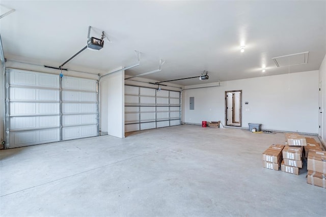 garage with a garage door opener and electric panel