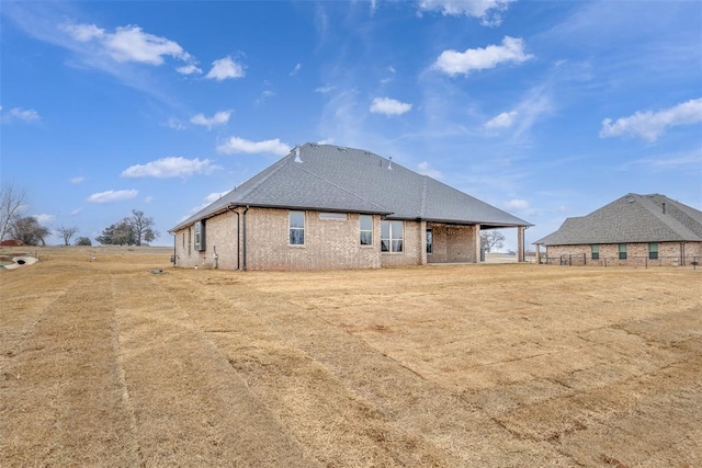 rear view of house with brick siding