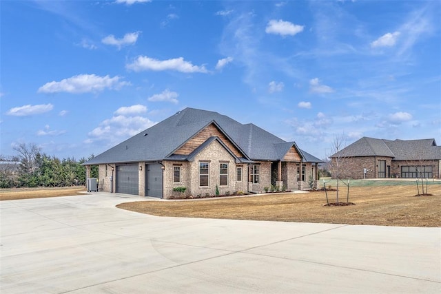 view of front of house with brick siding, roof with shingles, a garage, driveway, and a front lawn