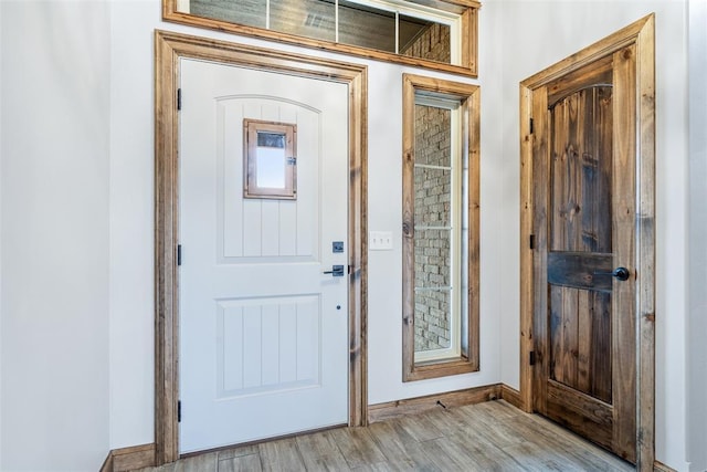 entrance foyer featuring light wood-style flooring and baseboards