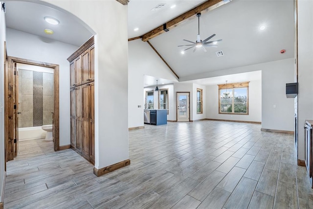 unfurnished living room featuring visible vents, wood tiled floor, ceiling fan, high vaulted ceiling, and beamed ceiling