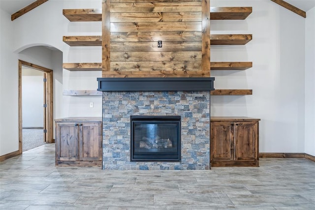 room details featuring a fireplace and baseboards