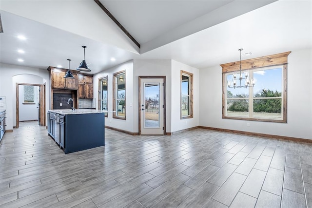 kitchen featuring decorative light fixtures, recessed lighting, light wood-style flooring, an inviting chandelier, and vaulted ceiling