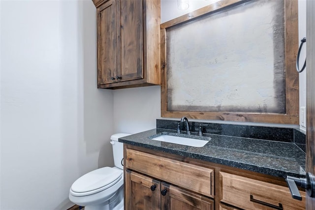 half bathroom with toilet and vanity