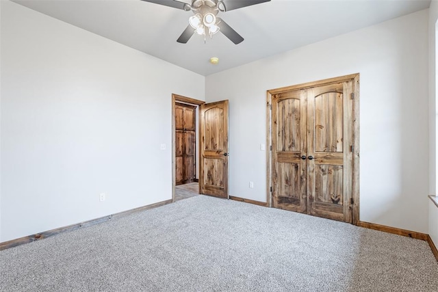 unfurnished bedroom with carpet floors, a ceiling fan, and baseboards