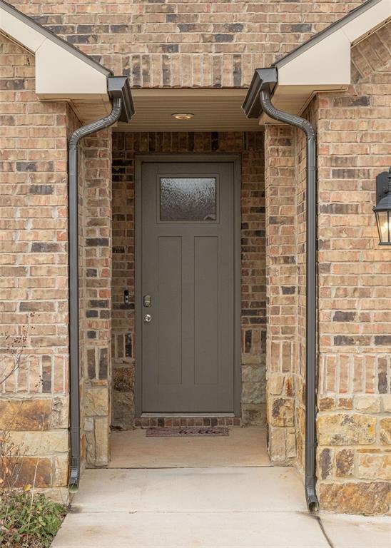 property entrance with brick siding