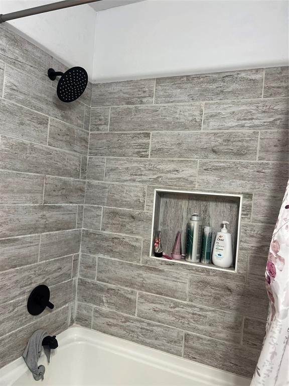 bathroom with shower / bath combination with curtain