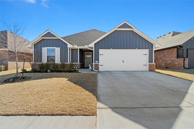 view of front of house with board and batten siding, concrete driveway, a shingled roof, and an attached garage