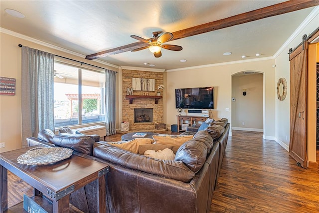 living room with a ceiling fan, crown molding, arched walkways, a barn door, and dark wood-style floors