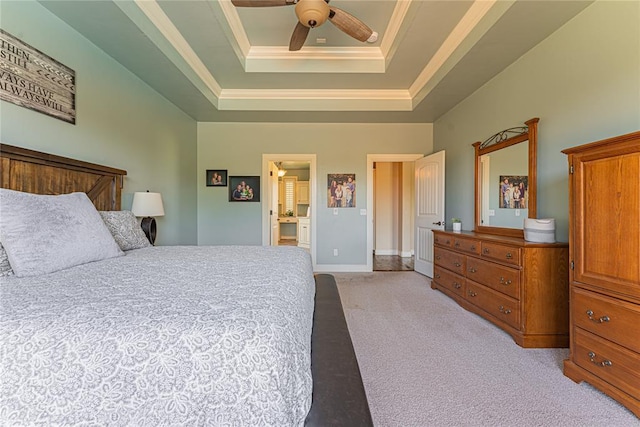 bedroom featuring ceiling fan, light colored carpet, baseboards, a tray ceiling, and ornamental molding