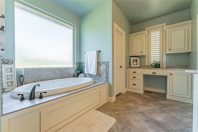 full bathroom featuring a garden tub and baseboards