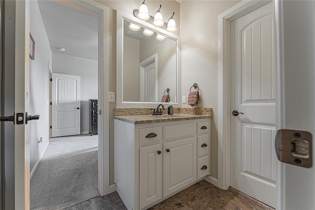 bathroom with vanity and baseboards