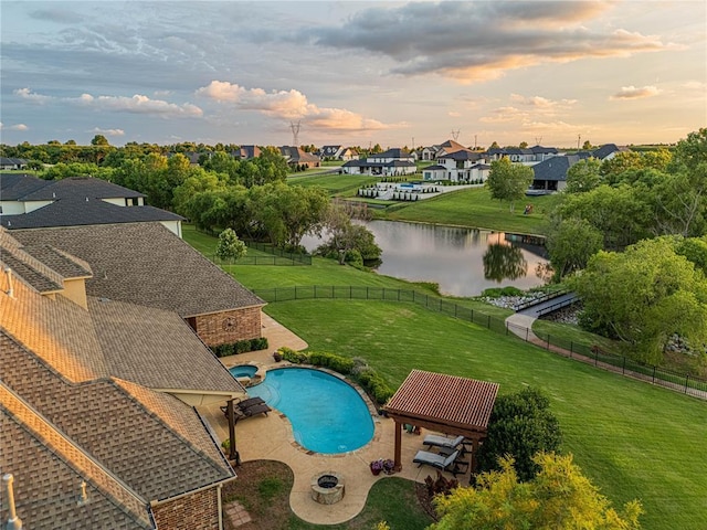 view of pool featuring a fenced backyard, a patio area, a lawn, a water view, and a residential view