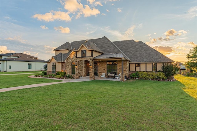 view of front of home with stone siding and a front yard