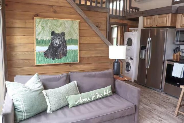 161720 N 4335th Rd, Clayton, OK 74536 - living area featuring stacked washer / dryer, wood finished floors, and wooden walls