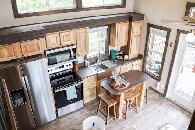 161720 N 4335th Rd, Clayton, OK 74536 - kitchen featuring appliances with stainless steel finishes, dark countertops, a sink, and light wood finished floors