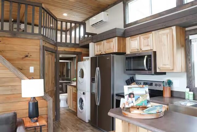 161720 N 4335th Rd, Clayton, OK 74536 - kitchen featuring wooden ceiling, a wall mounted air conditioner, stainless steel appliances, stacked washer / dryer, and dark countertops
