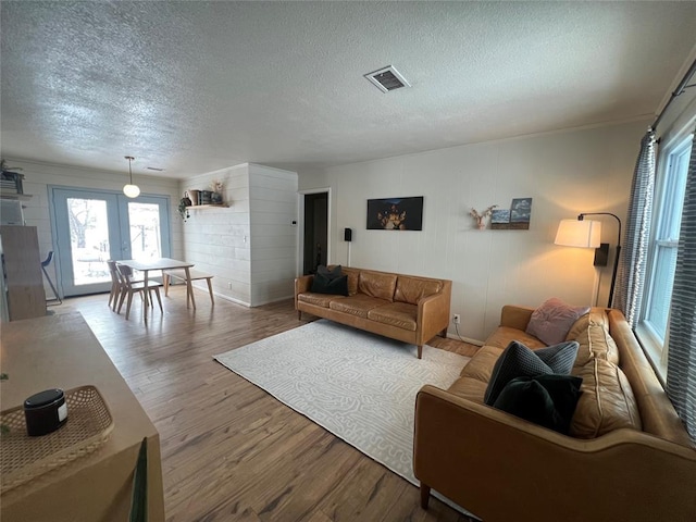 living room with a textured ceiling and hardwood / wood-style floors