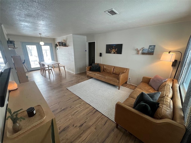 living room featuring a textured ceiling and wood-type flooring