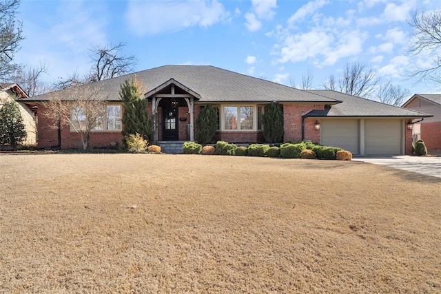 single story home featuring brick siding, an attached garage, and concrete driveway